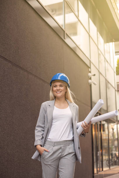 Female arhitect walking,holding project
